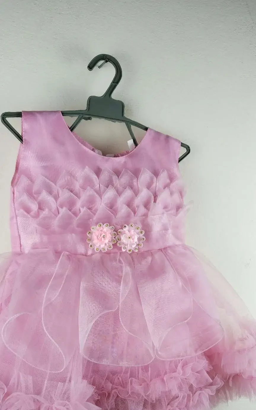 Light Pink Party Dress for Girls with floral top design, flower waist detail, and fluffy layered skirt for special occasions