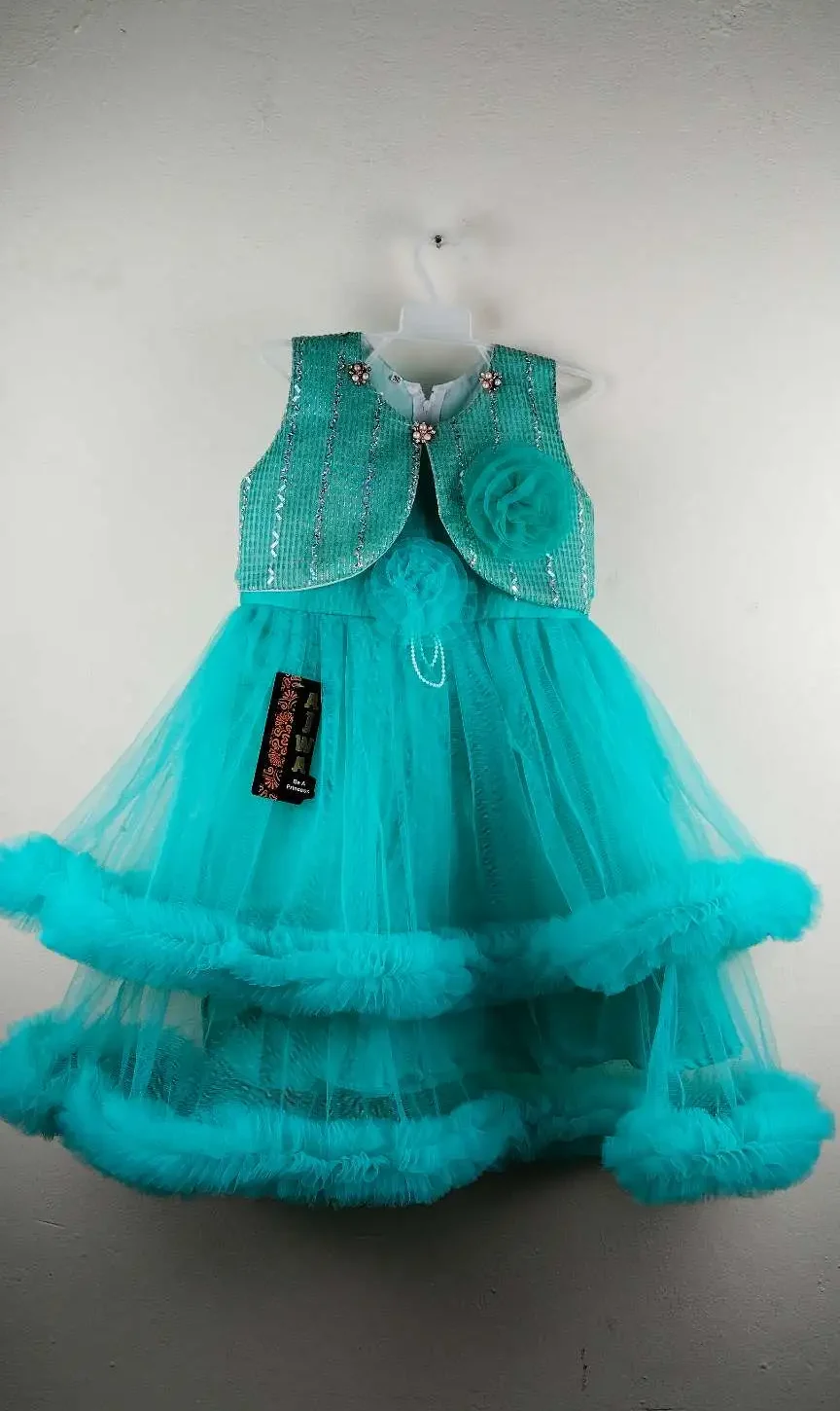 Girls Turquoise Dress with Net Frock and Jacket for girls with floral print skirt, matching jacket, and belt, displayed on hanger against plain wall