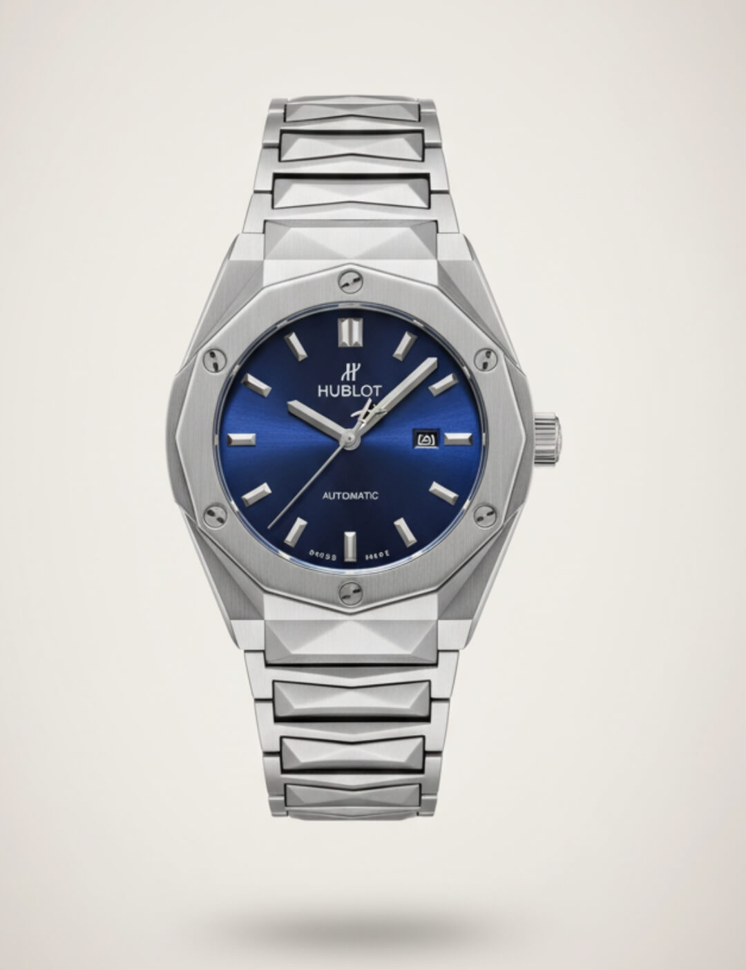 Front-facing studio photo of a silver Hublot Automatic Blue Dial Watch with an octagonal brushed-steel case, integrated metal bracelet, blue sunburst dial, silver hour markers and hands, and a date window at 3 o’clock, on a light neutral background.