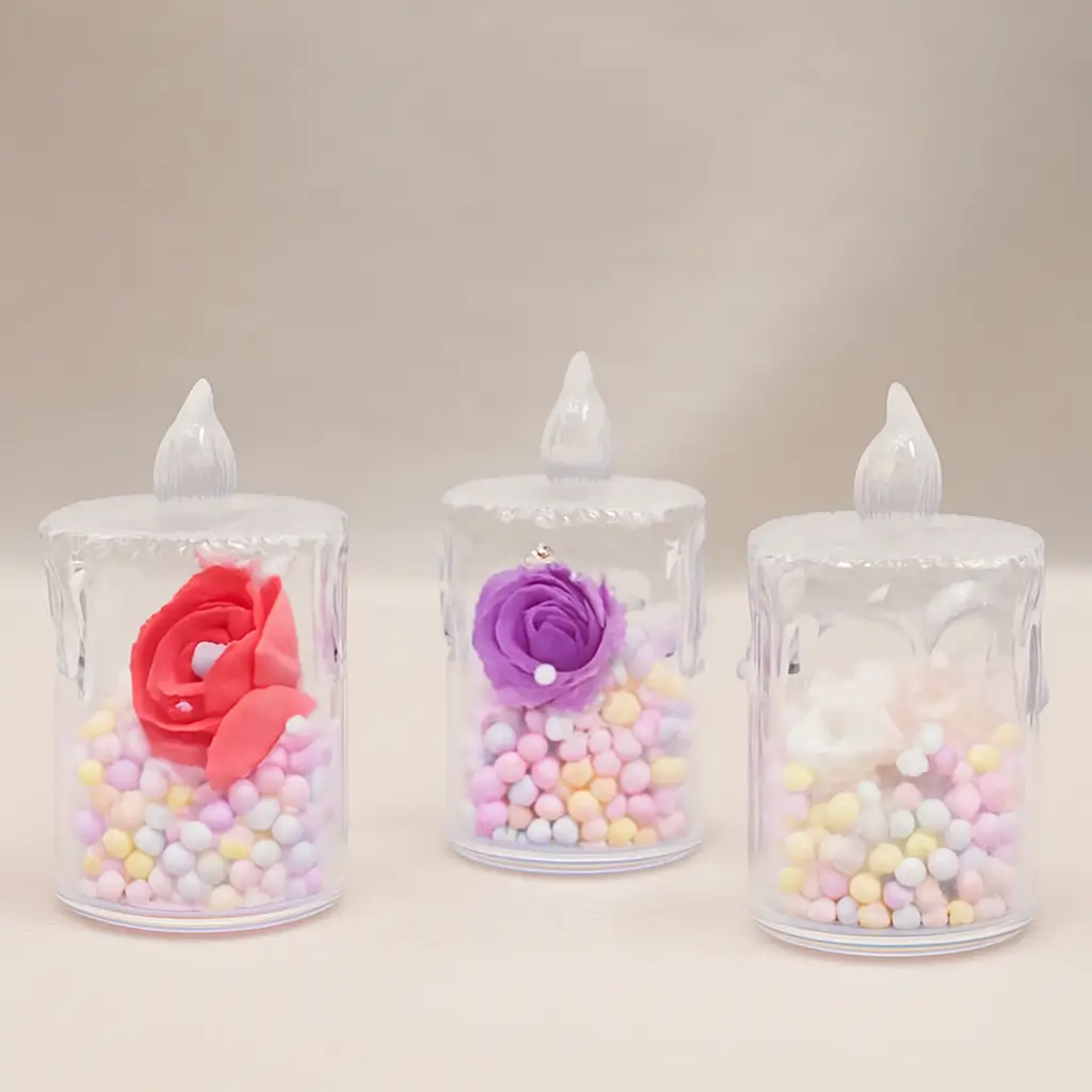 Set of decorative flameless LED candles with colorful artificial roses and pastel beads inside transparent holders, perfect for parties, weddings, and festive décor.